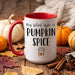 A white ceramic coffee mug with a red handle and red interior, printed with the phrase 'My blood type is PUMPKIN SPICE' and a small coffee cup graphic. The mug is styled on a rustic wooden surface with pumpkins, autumn leaves, cinnamon sticks, and a knitted blanket in the background.